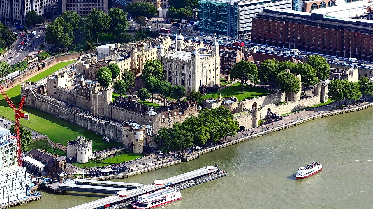 The Tower of London seen from above, with the White Tower at the centre of its concentric walls beside the Thames