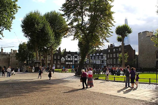 Tower Green inside the Tower of London, with its lawn, tall plane trees and half-timbered Tudor houses